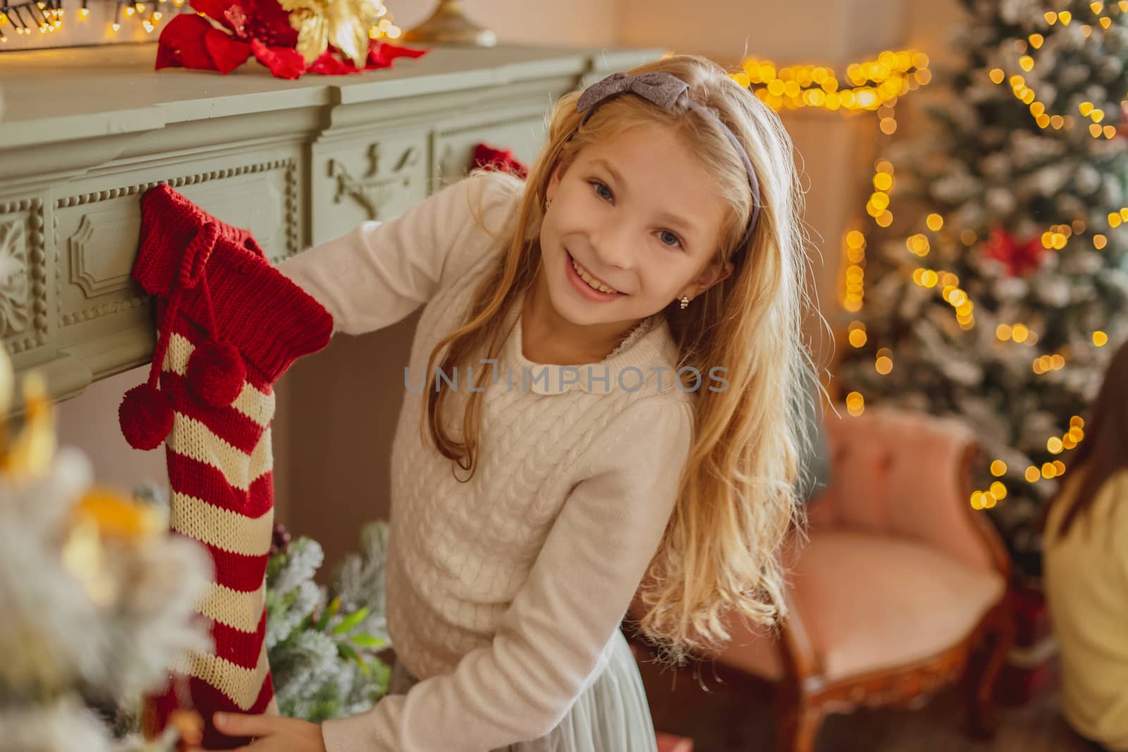 Excited cute teen girl taking present from Christmas socks