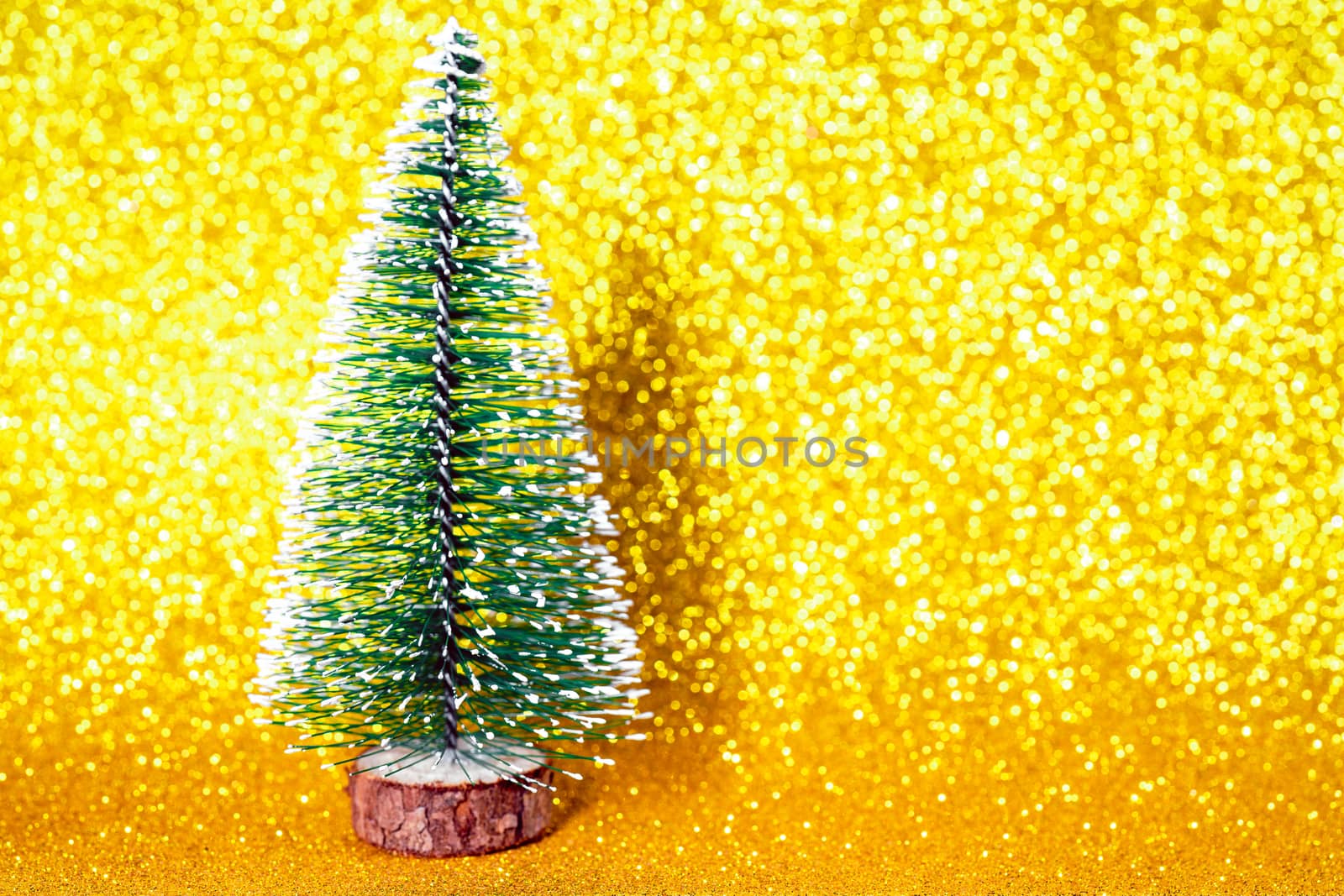 Green christmas tree on shiny background. Beautiful bokeh.