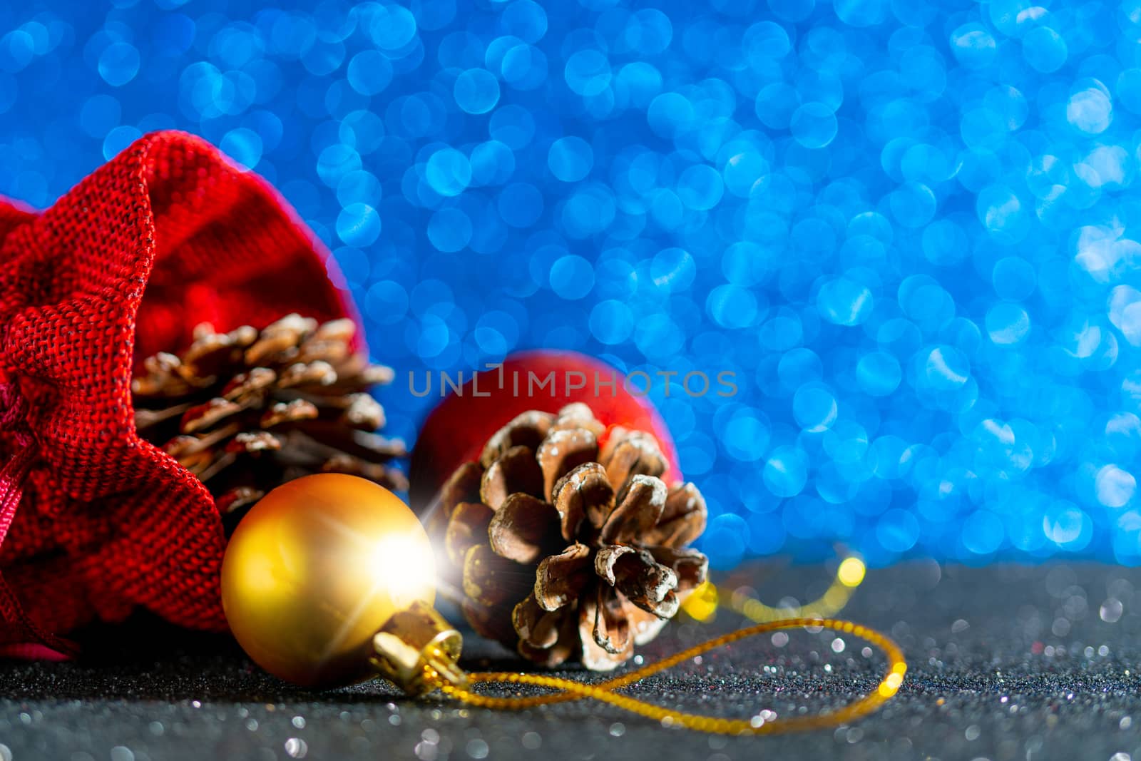 Christmas blue background. Red gift bag and Christmas toys.
