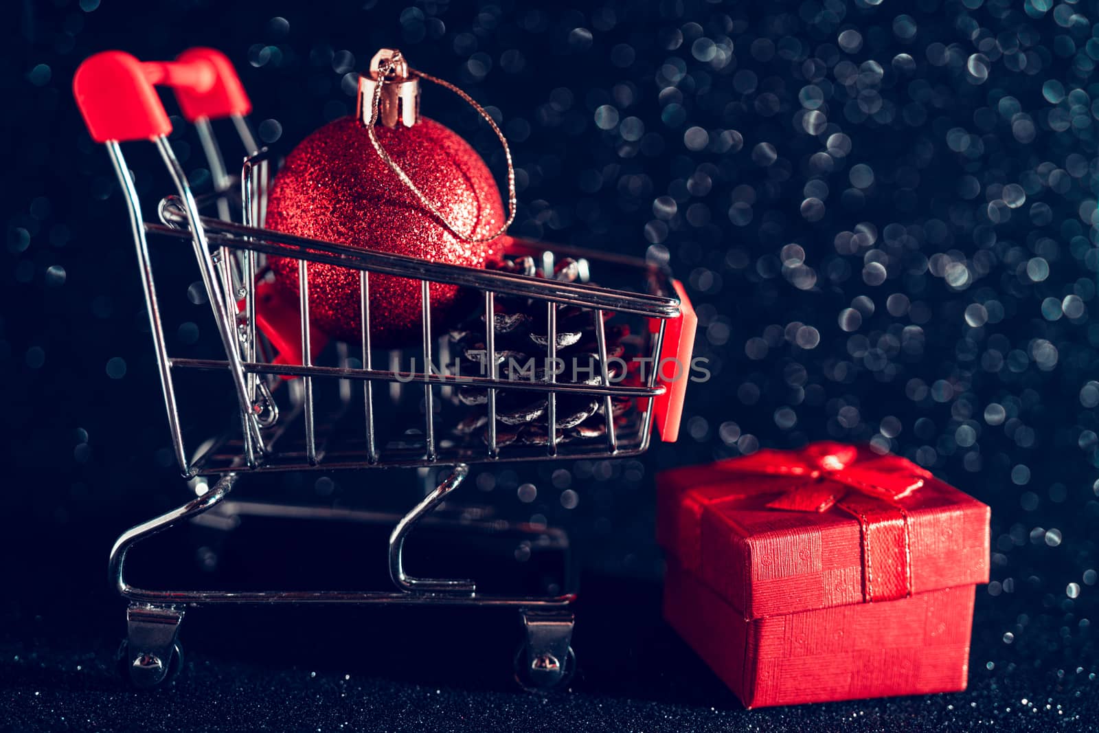 Christmas toys and gifts on shiny dark background.