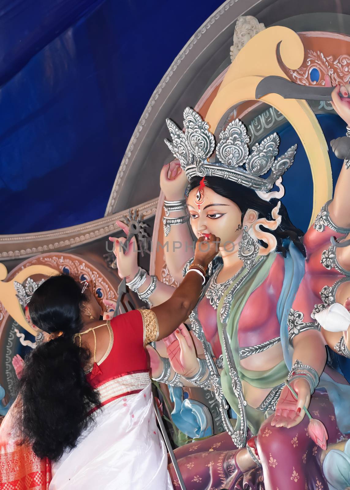 Kolkata October 2019 - Hindu devotee feeding sweets to Maa Durga and wish good luck for her journey back home at Vijaya Dashami in Durga puja Festival. A sorrowful ritual to bid farewell to the deity. by sudiptabhowmick