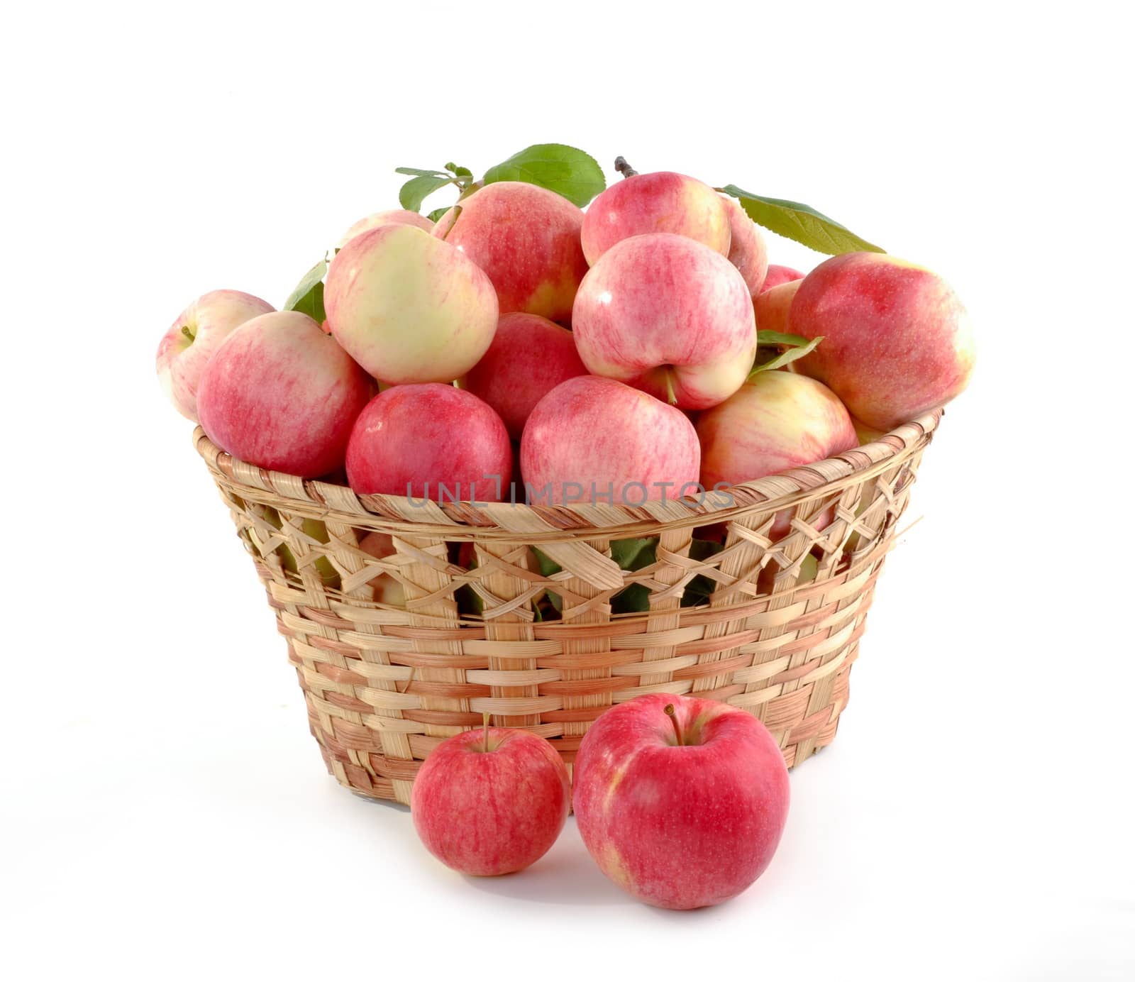 In images Wicker basket full of apples isolated on white