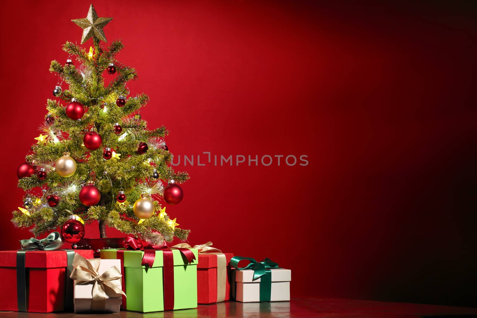 In images Beautiful decorated christmas tree with present boxes in a winter landscape with snow