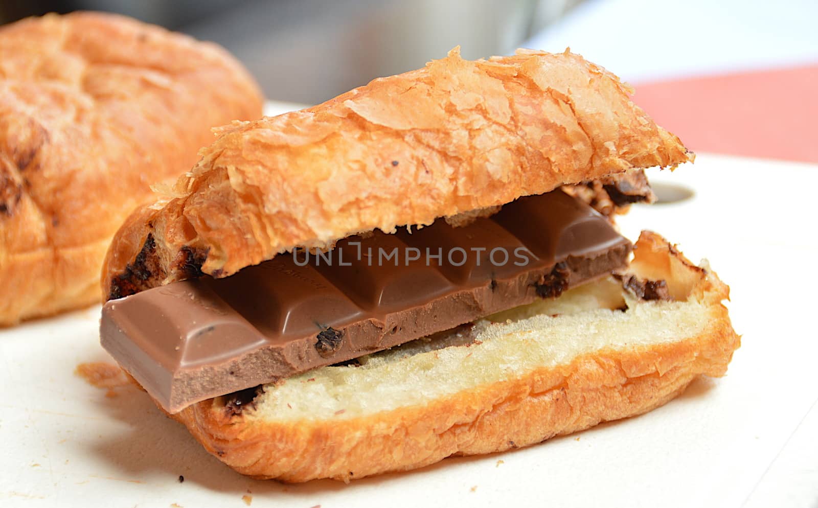 In images freshly baked croissant decorated with chocolate sauce isolated on white background, top view