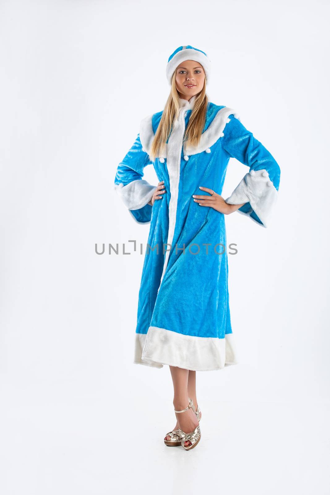 Young beautiful girl in a carnival clothing on a studio background