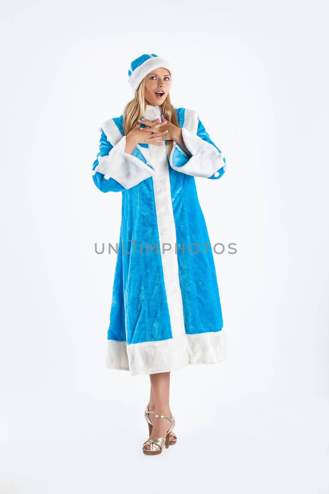 Young beautiful girl in a carnival clothing on a studio background