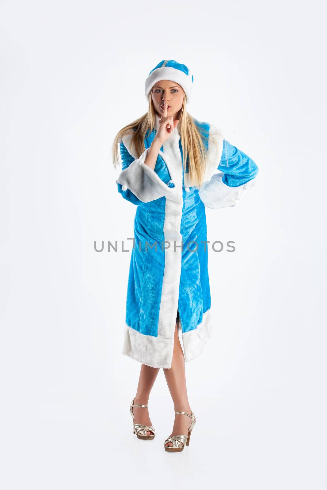 Young beautiful girl in a carnival clothing on a studio background