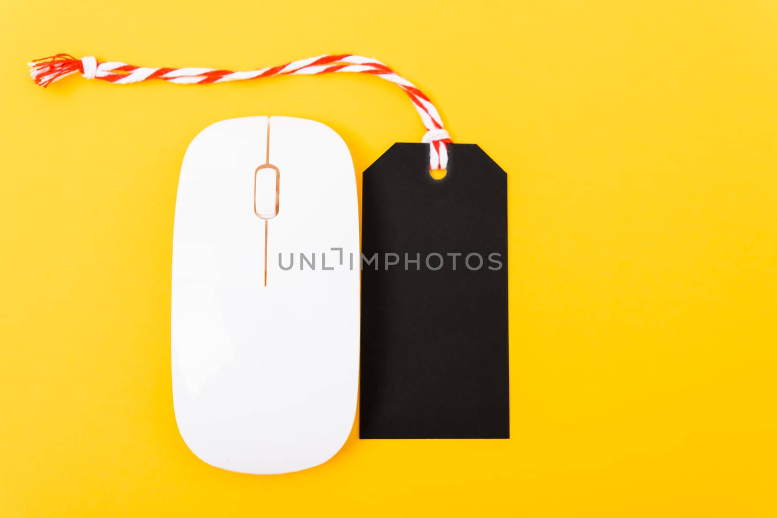 Online shopping Blank black tag on white mouse with yellow background