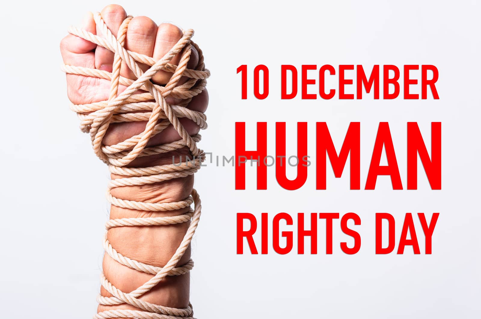 Rope on fist hand with 10 december HUMAN RIGHTS DAY text by Sorapop