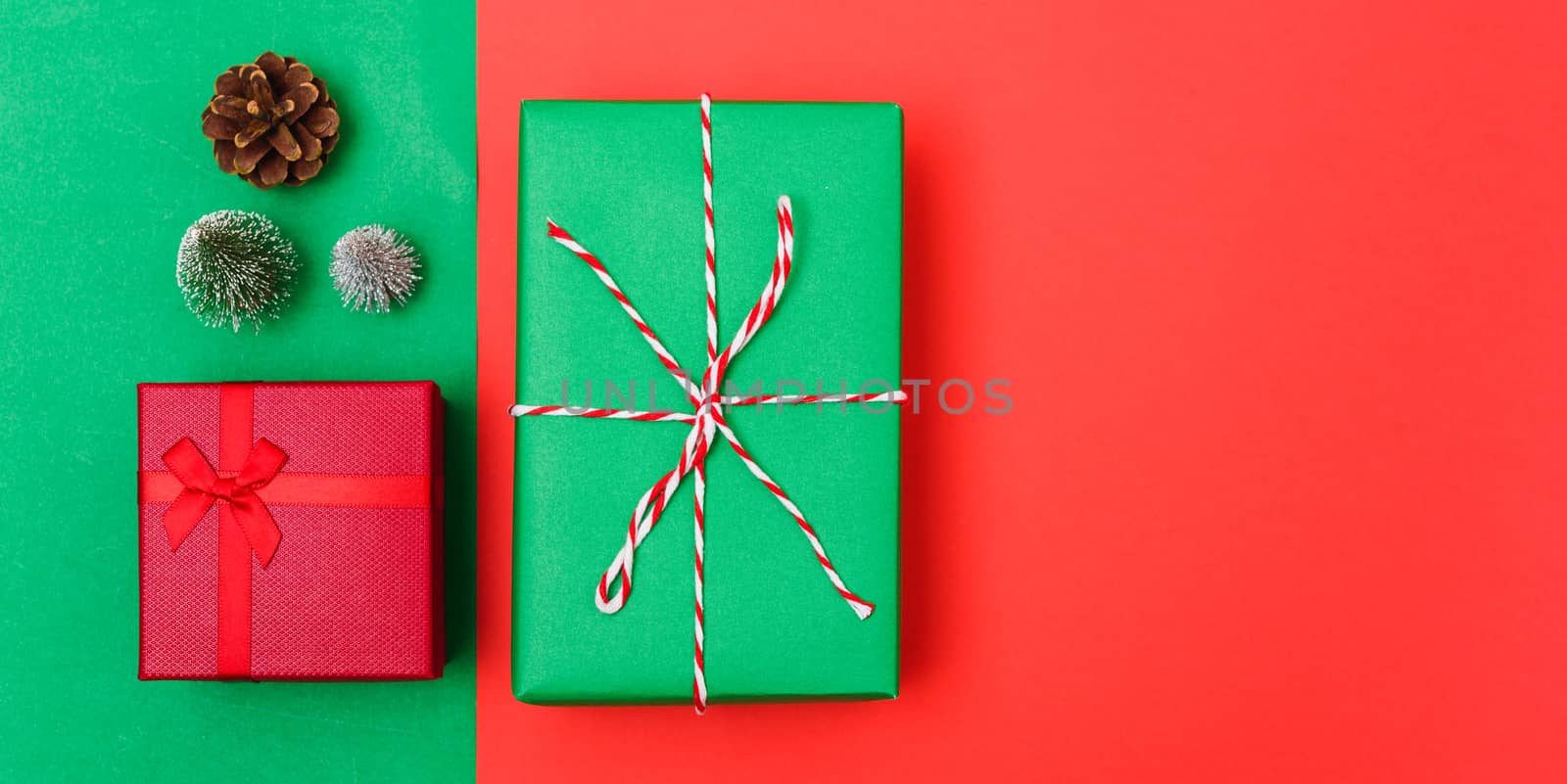 New Year, Christmas Xmas holiday composition, Top view with gift box, clews of rope, green fir tree branch on red and green background with copy space