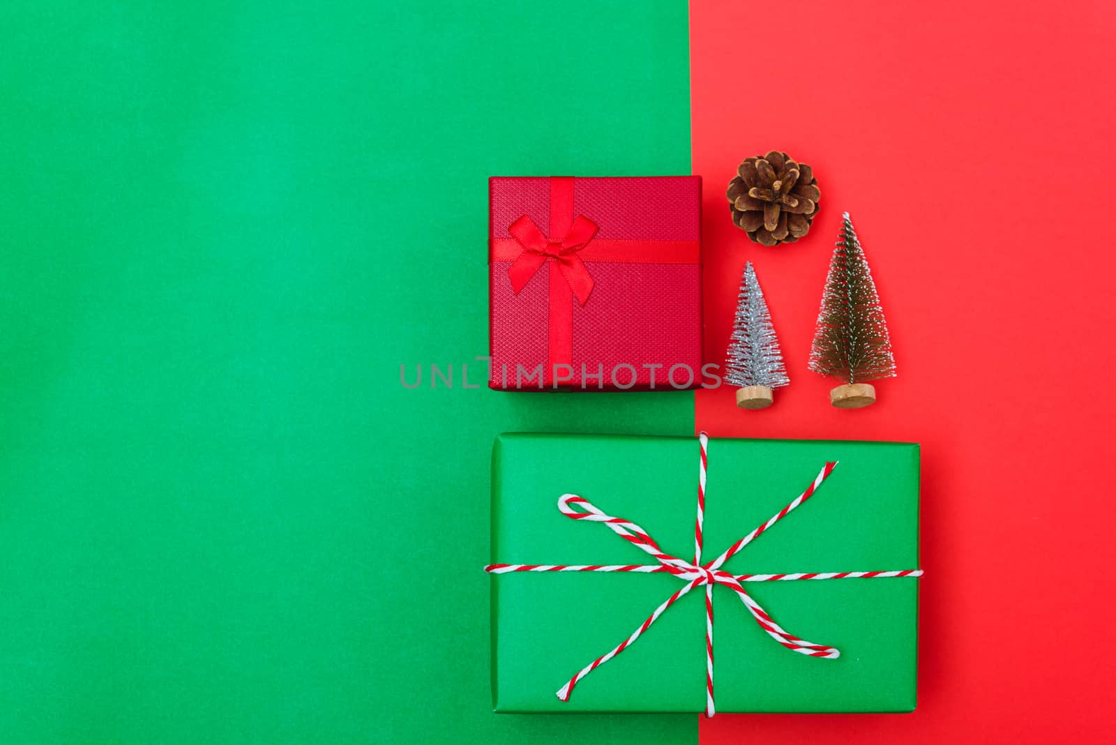 New Year, Christmas Xmas holiday composition, Top view with gift box, clews of rope, green fir tree branch on red and green background with copy space