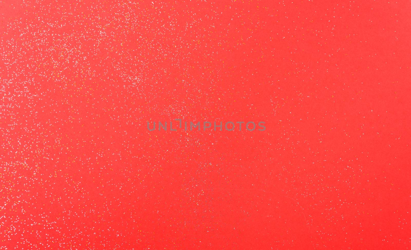 Shiny particles glitter on red background Christmas decorative with copy space