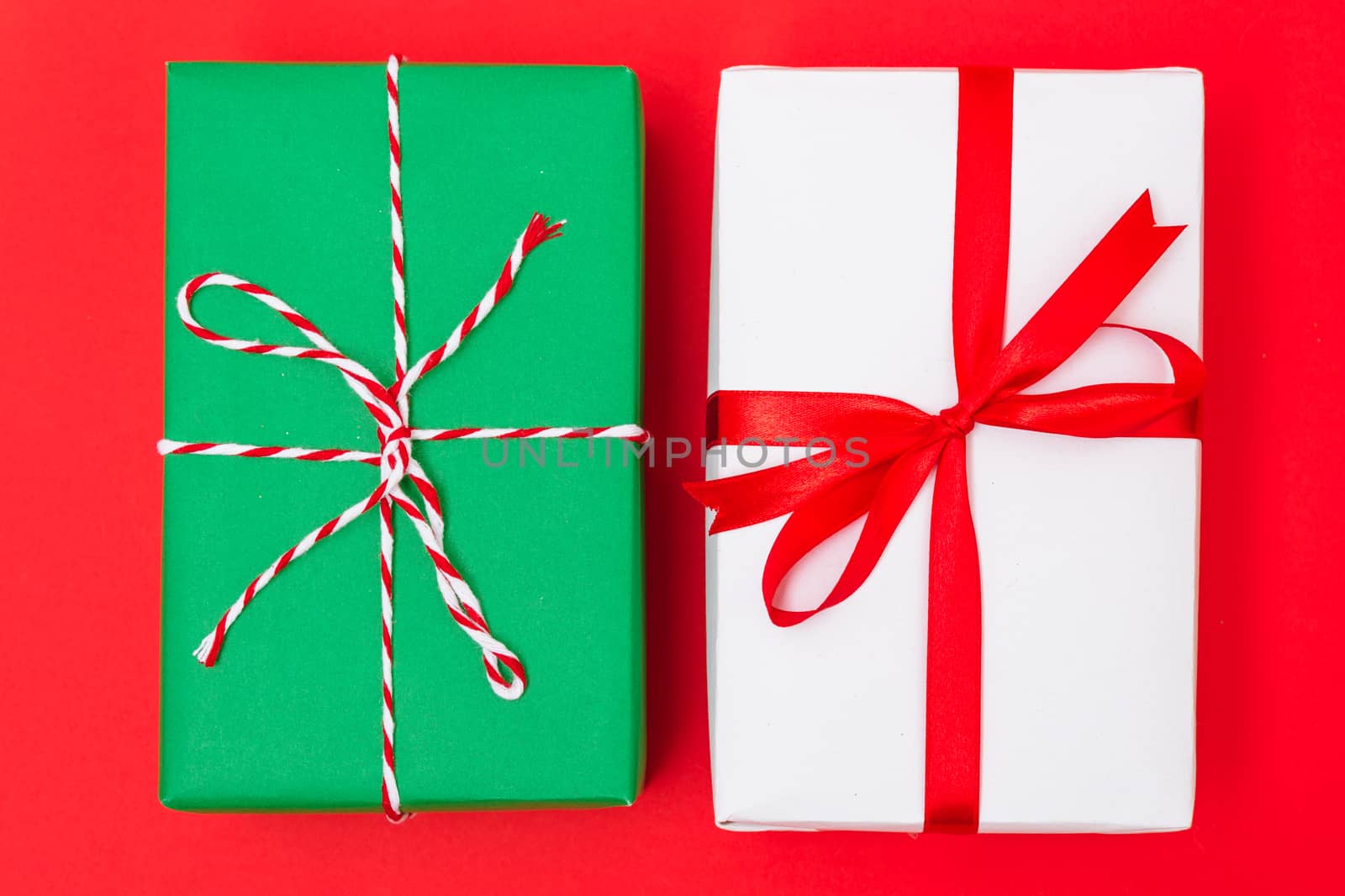 Happy New Year and Christmas 2020 day, top view Xmas white and green gift boxes on red background with copy space for your text