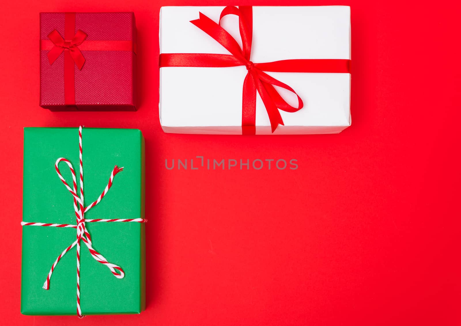 Happy New Year and Christmas 2020 day, top view Xmas multi color gift boxes on red background with copy space for your text
