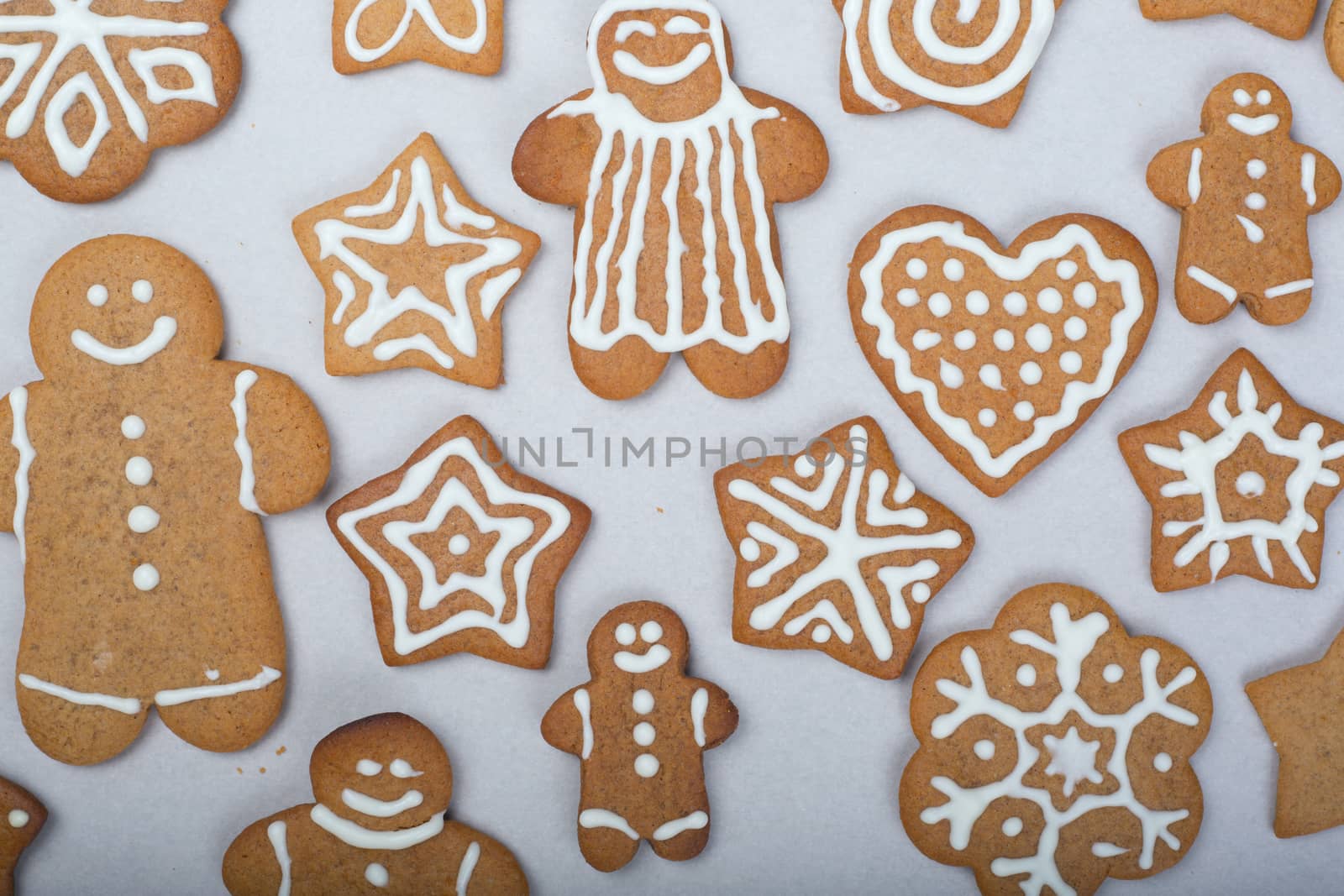 Gingerbread men stars and snowflakes glazed cookies Christmas background