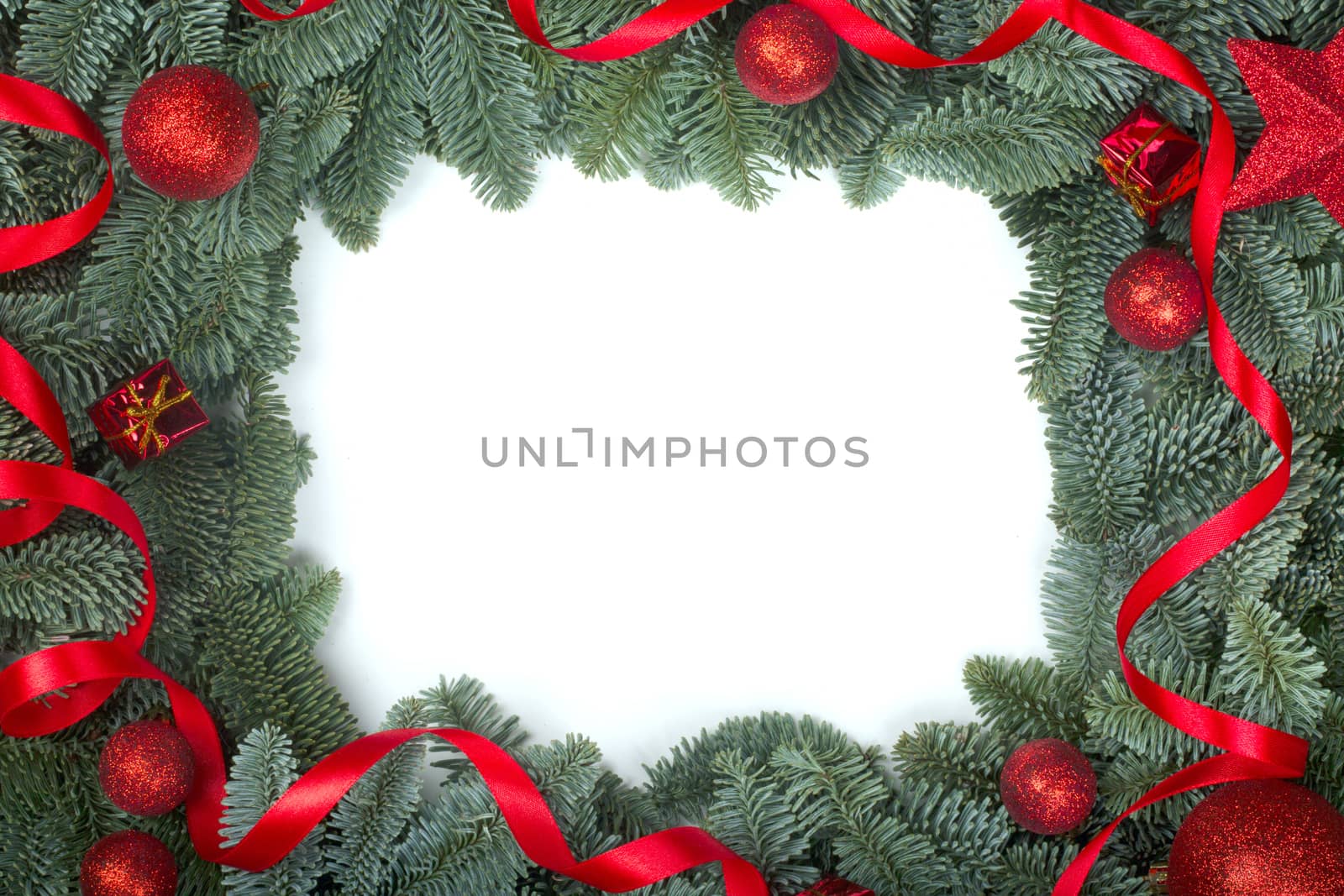 Christmas design boder frame greeting card of noble fir tree branches and red baubles isolated on white background