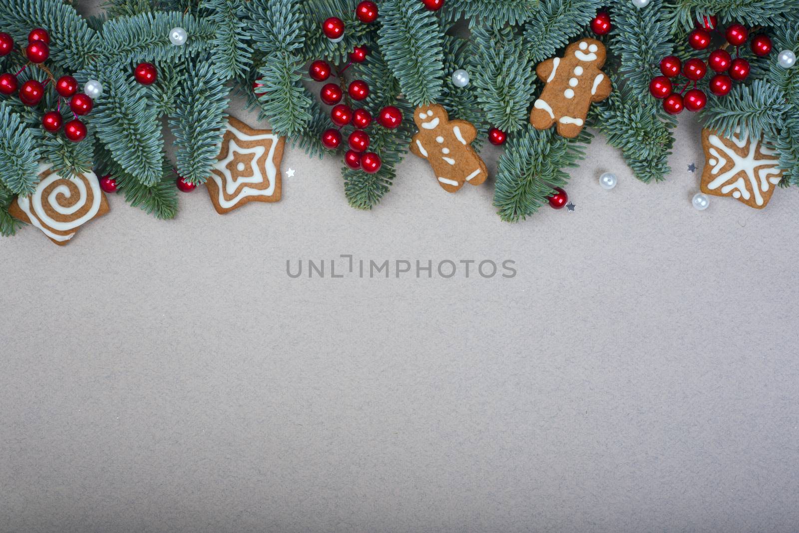 Christmas noble fir tree twigs gift and decorations on brown paper background with copy space for text