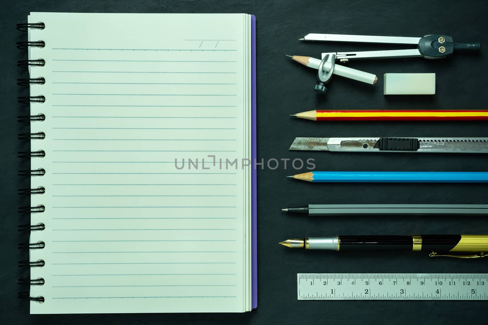 Stationery and notebook on blackboard. Concept of architecture office or back to school. Top view and copy space for text.