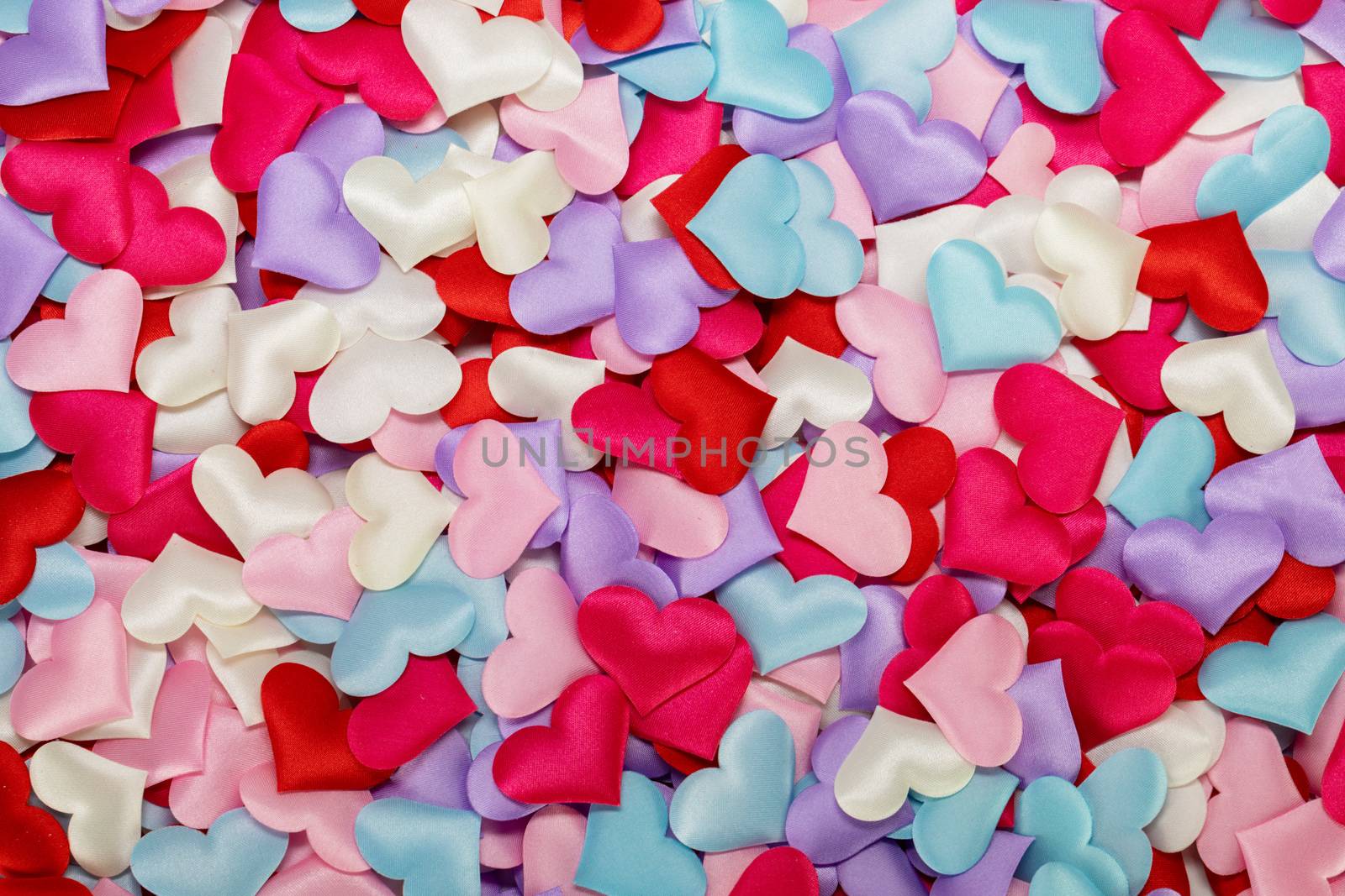Many satin colorful hearts background. St Valentines Day. Congratulations card on Valentine Day