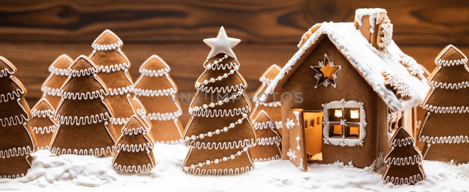 Gingerbread house and christmas fir trees winter holiday celebration concept