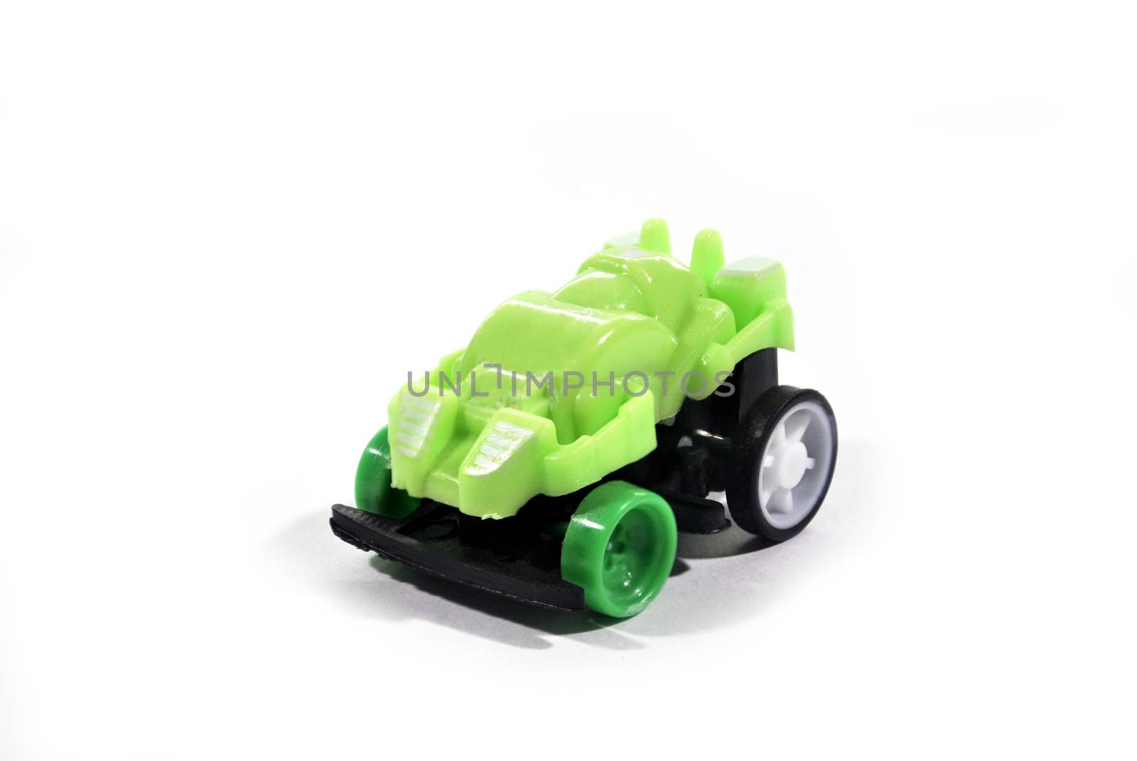 The green toy car is a collection put on a white background.