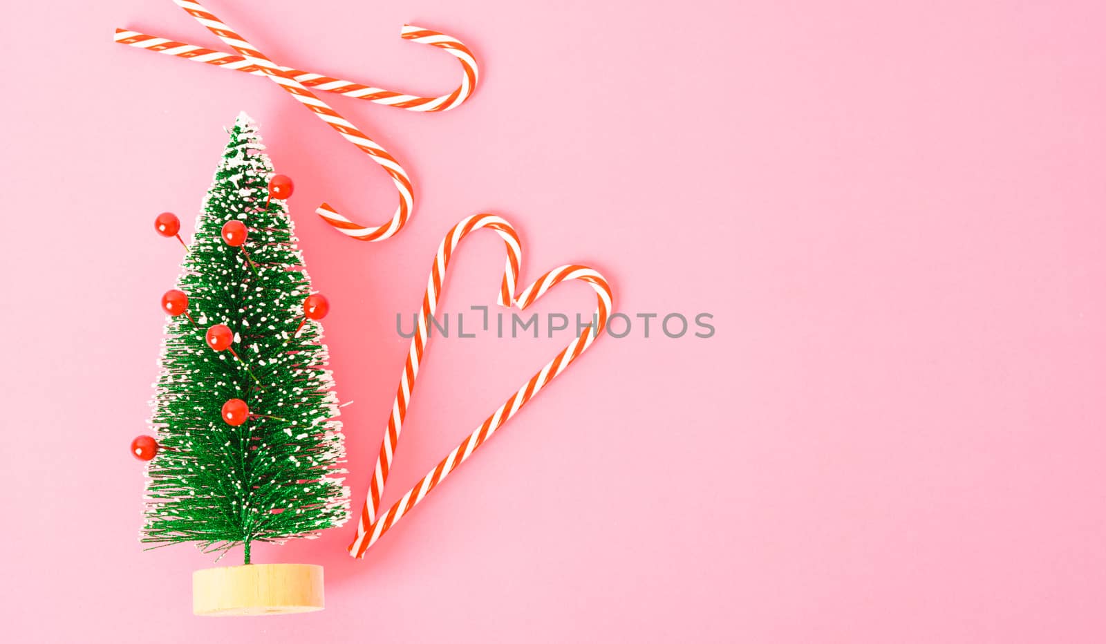 Happy New Year and Christmas day, top view flat lay composition decoration tree fir branch on pink background with copy space for your text