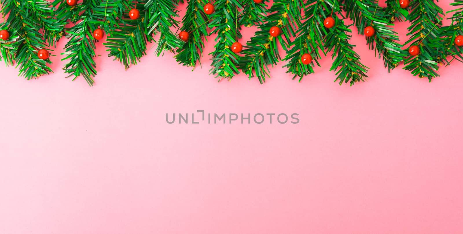 Happy New Year and Christmas day, top view flat lay composition decoration tree fir branch on pink background with copy space for your text