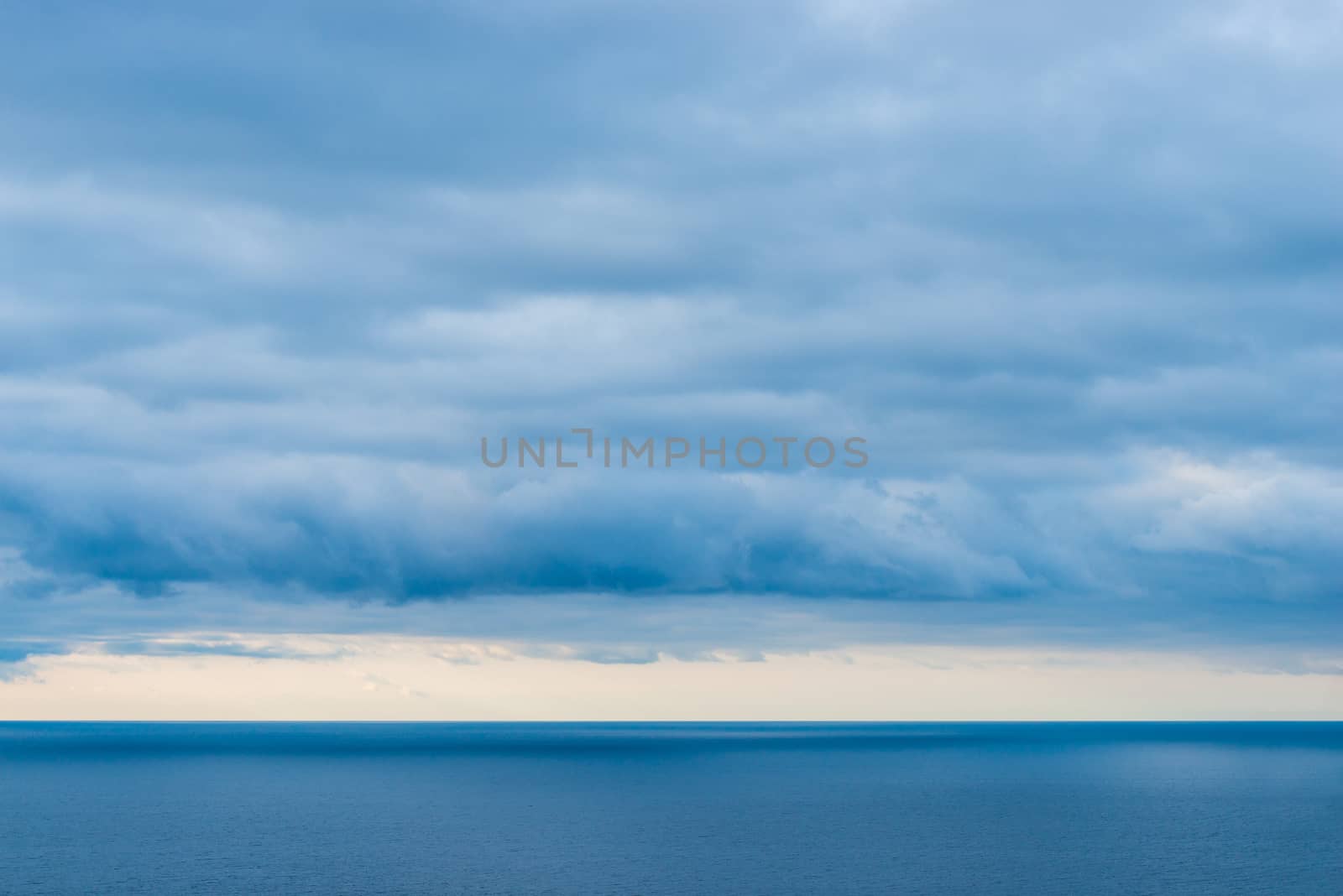 Landscape of the sea, view of the horizon, heavy rain clouds over the water
