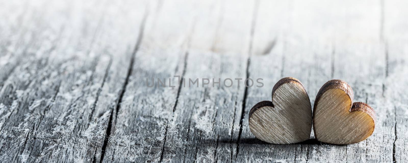 Two handmade wooden carved hearts on wood background couple relationship Valentine day concept