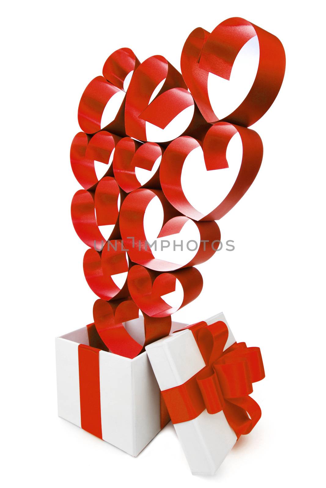 Gift in white box with pink ribbons and hearts isolated on white background
