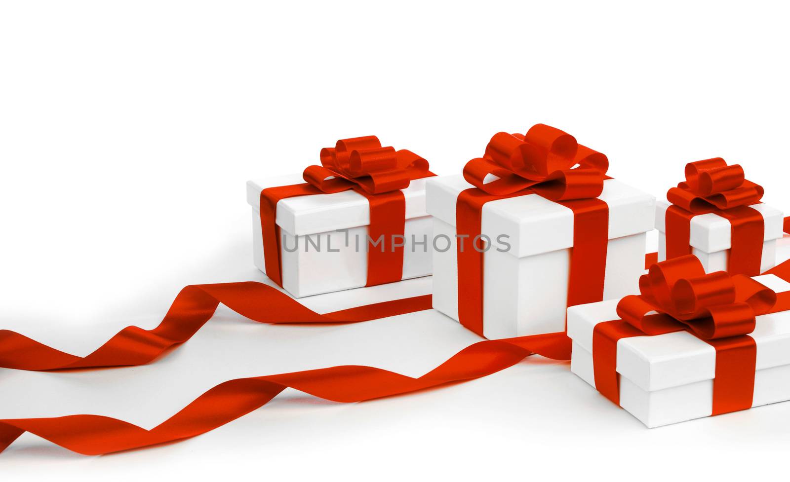 White gift boxes with red ribbons isolated on white background