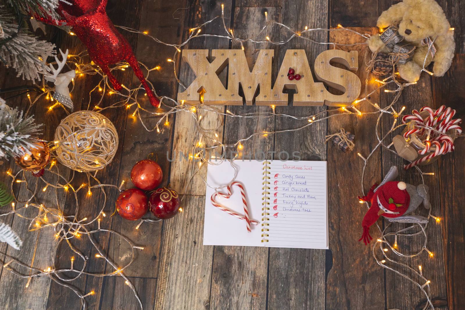 Christmas list on rustic wood with Christmas decorations.  Add your own message or list