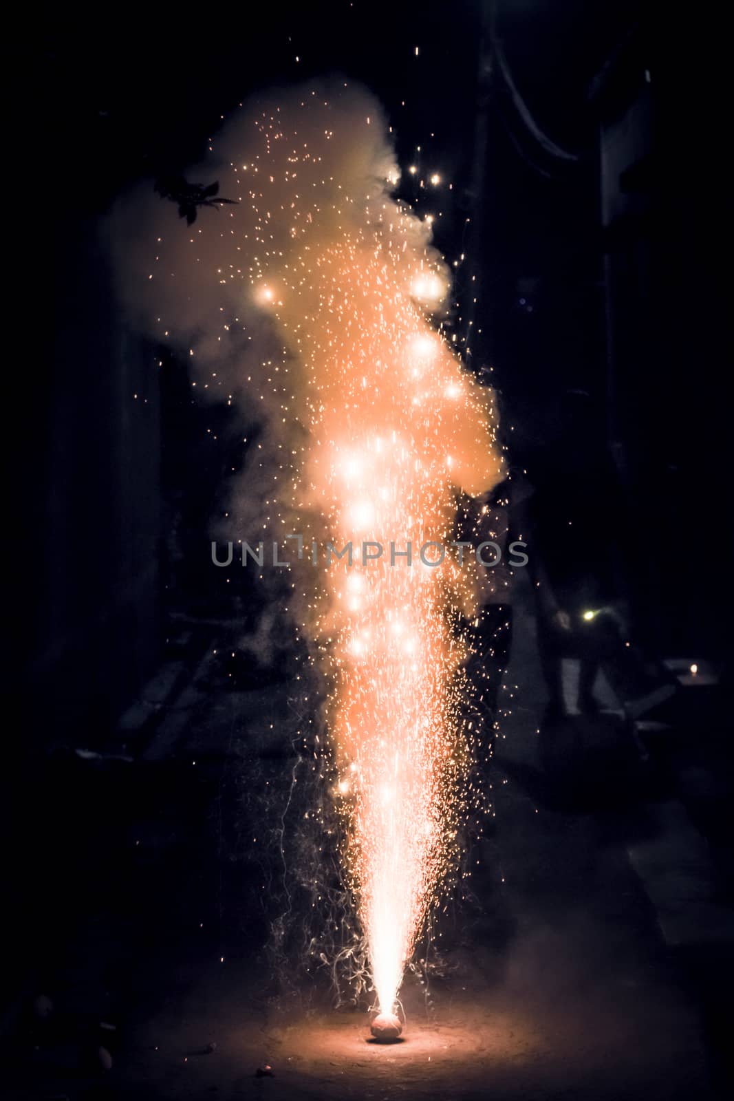 Bright and colorful fireworks showing display at night in City Street during Diwali festival celebration in Kolkata India. Close-up. Copy space room for text.
