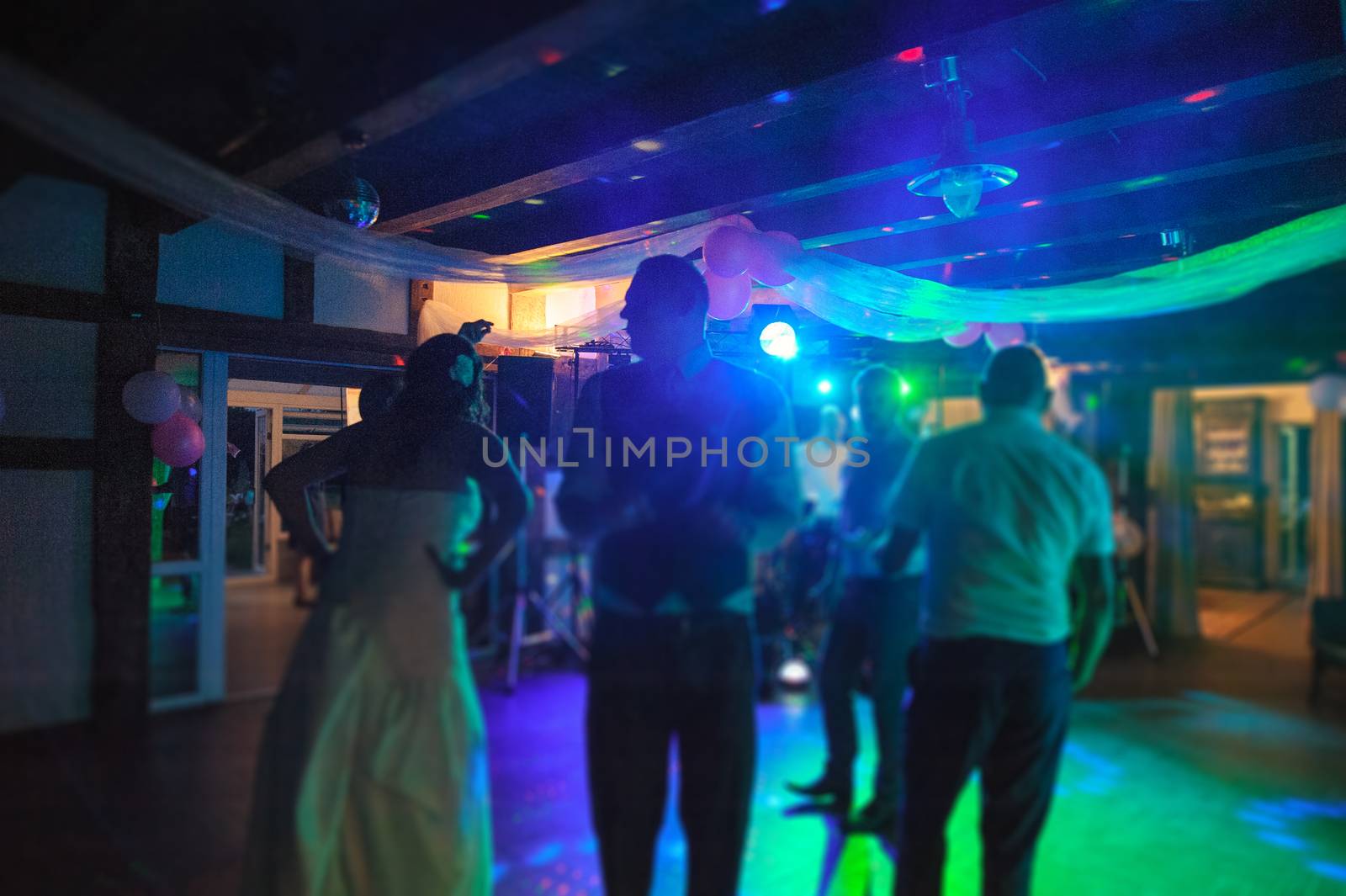 Bride and groom dancing the first dance at their wedding day. Guest on the dancefloor