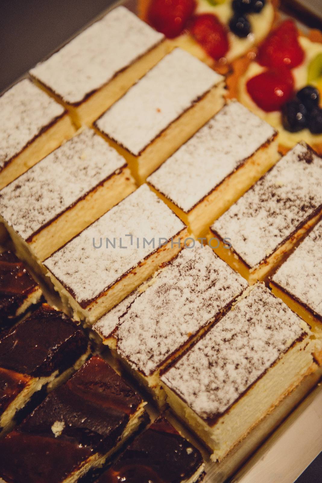 Delicious sweets on candy buffet. Wedding bakes on trays.