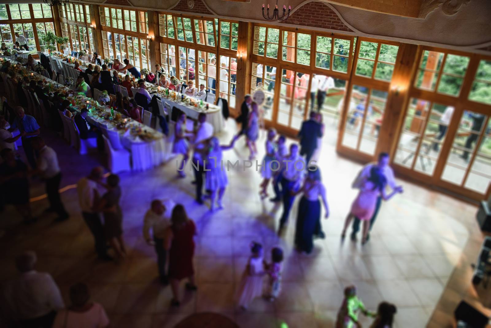 Bride and groom dancing the first dance at their wedding day. Guest on the dancefloor