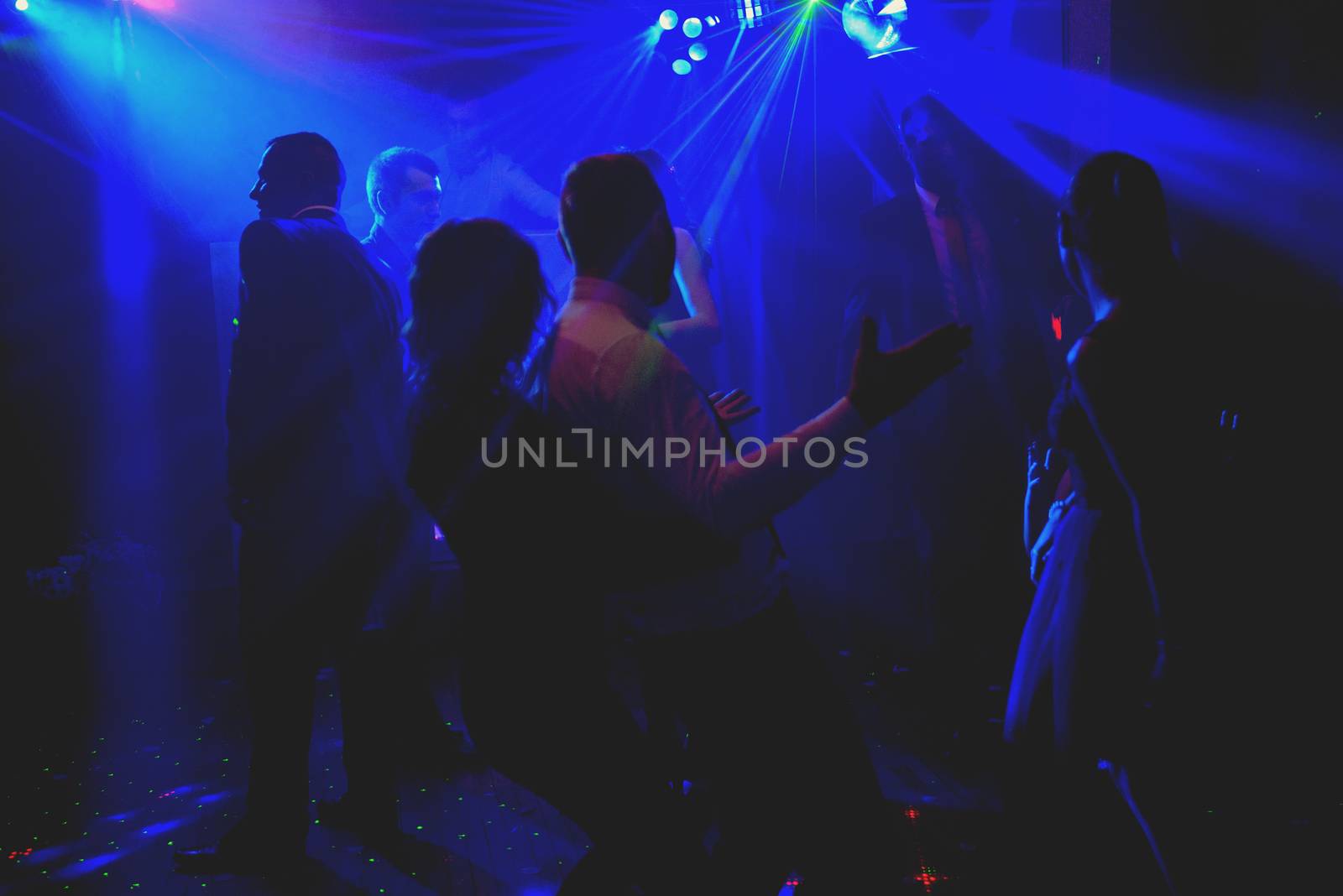 Bride and groom dancing the first dance at their wedding day. Guest on the dancefloor