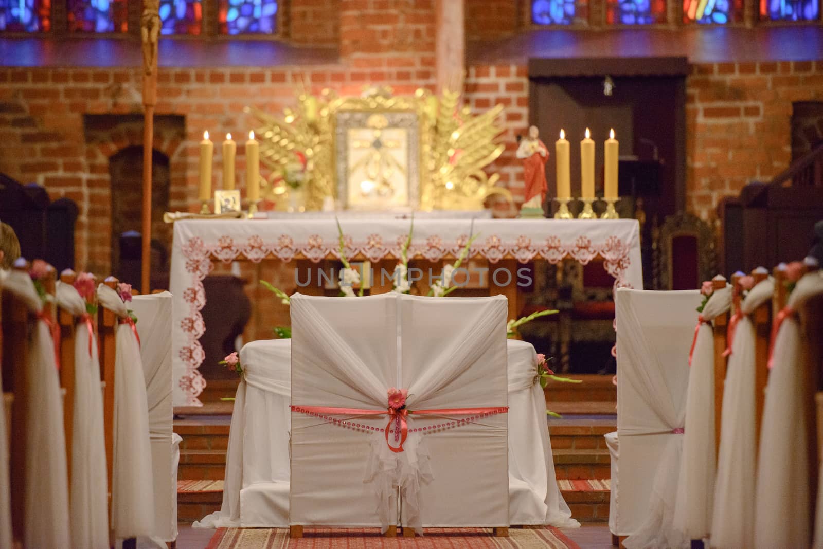Church sanctuary before a wedding ceremony. Empty chairs for bride and groom