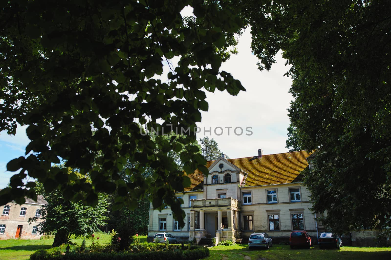 Renaissance historic palace in Poland, surrounding by beautiful green garden