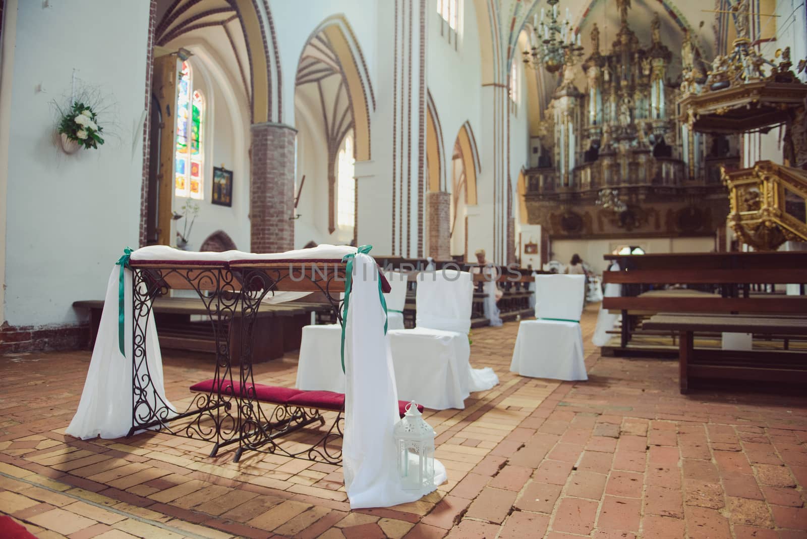 Church sanctuary before a wedding ceremony. Empty chairs for bride and groom