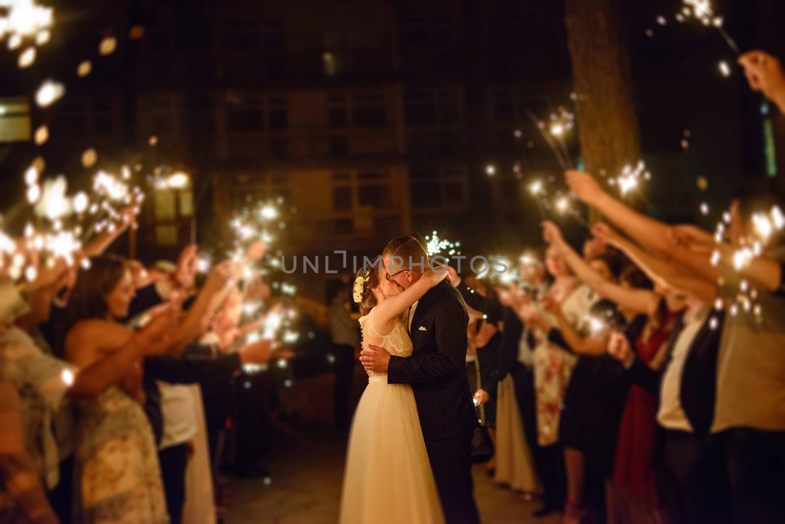 Bride and groom dancing the first dance at their wedding day. Guest on the dancefloor