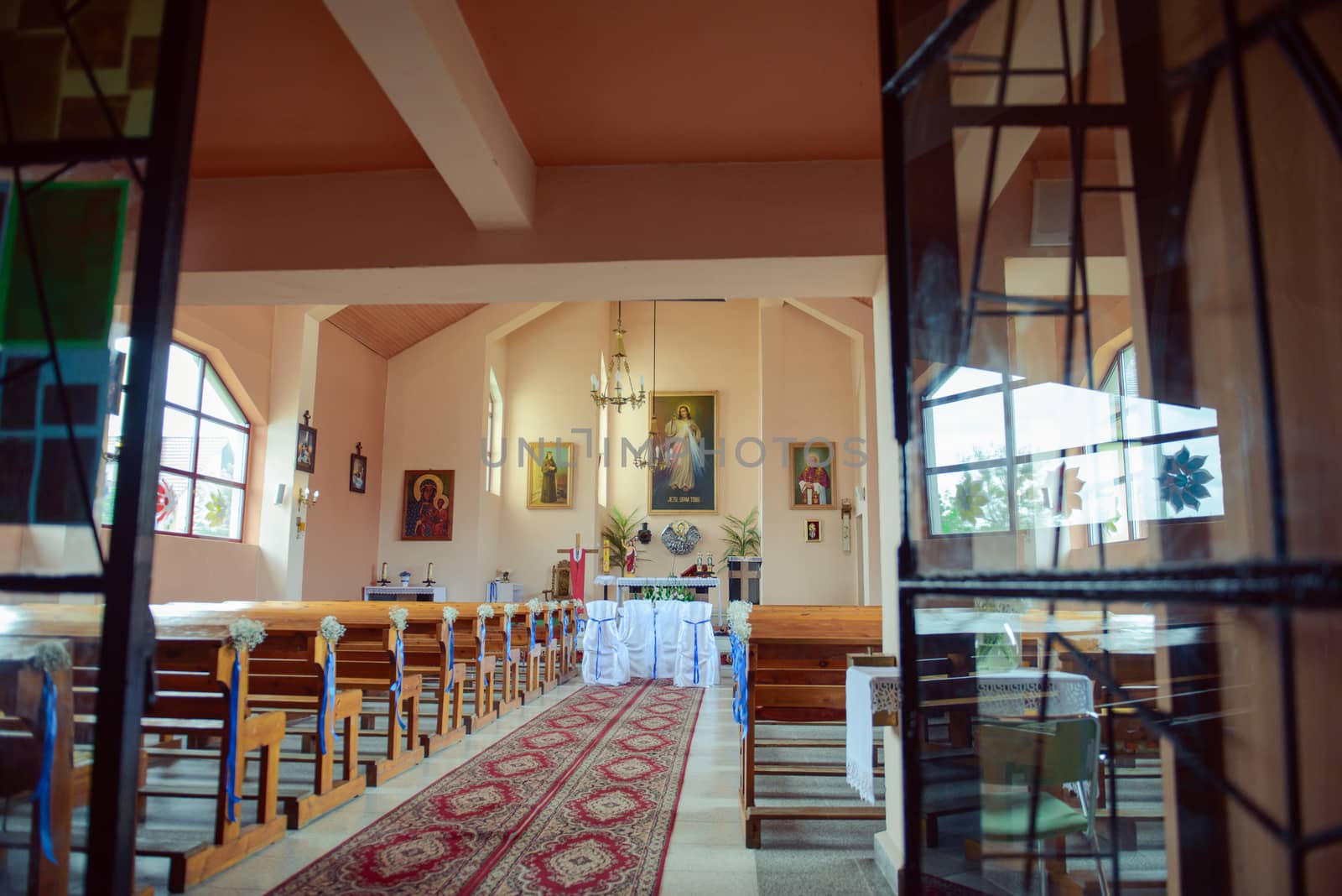 Church sanctuary before a wedding ceremony. Empty chairs for bride and groom