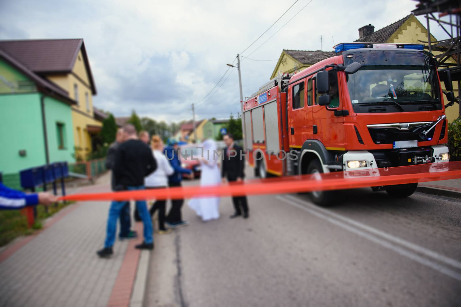 Beautiful wedding couple on outdoor photoshoot with fire truck