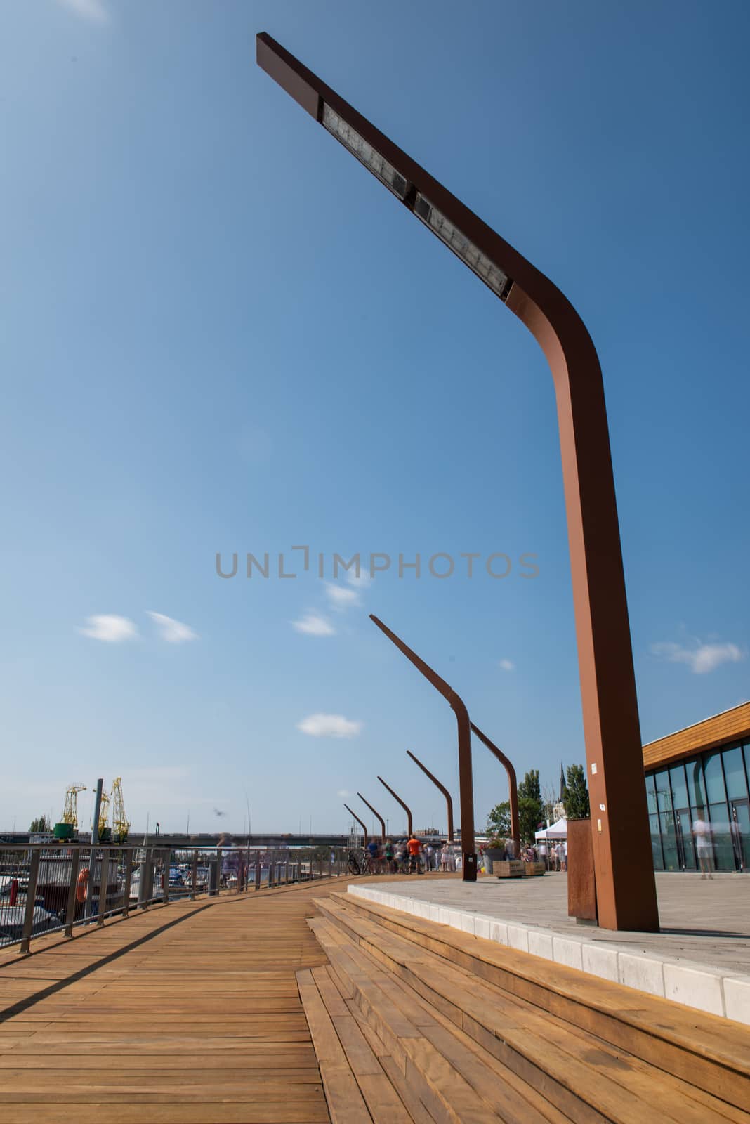 Modern and wooden marina club building in Szczecin, Poland. Boats, motorboat moored at the bank.