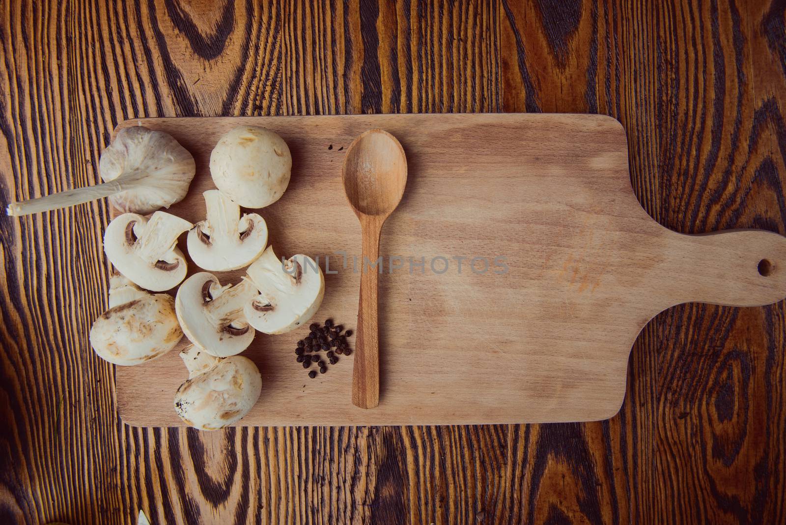 composition poured olive oil, mushrooms, garlic on wooden background. healthy food