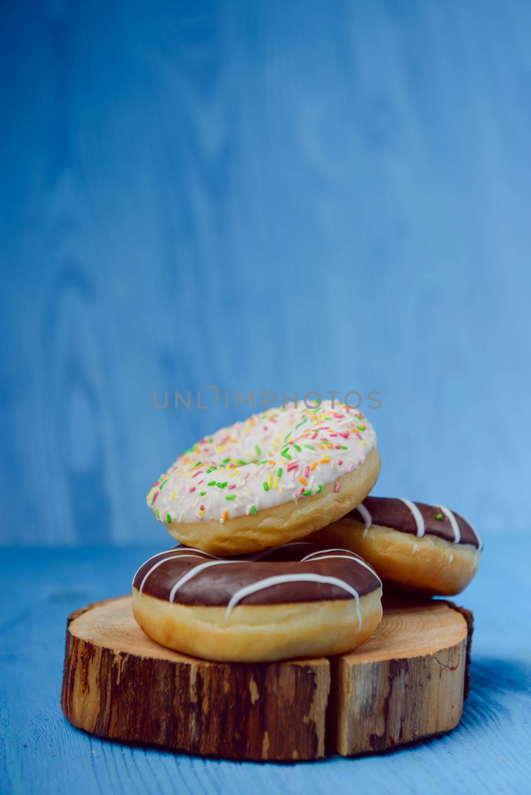 donuts lying on the table. blue background.