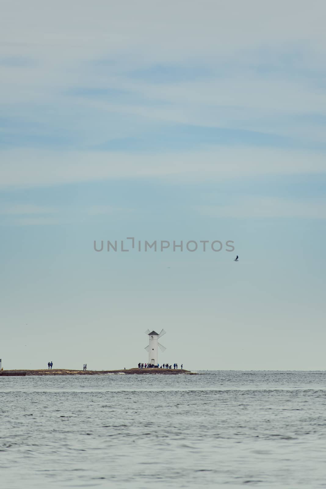 Old lighthouse in Swinoujscie, a port in Poland on the Baltic Sea. The lighthouse was designed as a traditional windmill. Panoramic image