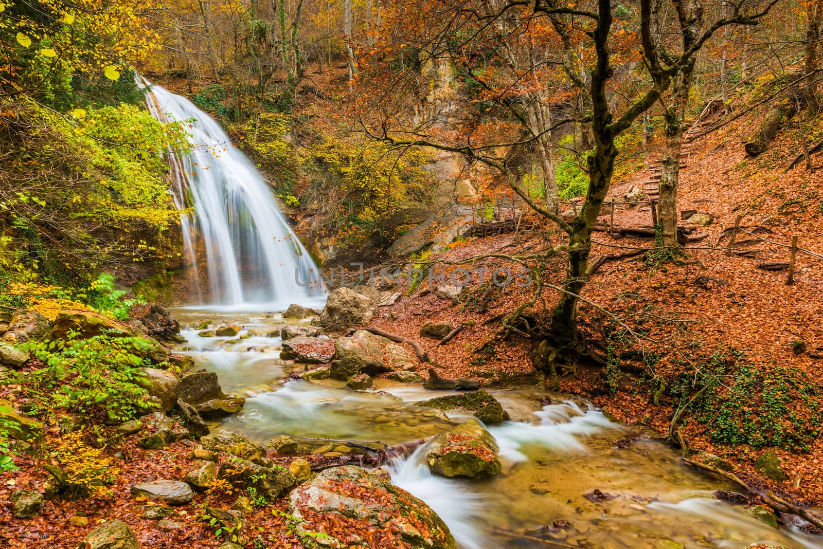 The natural attraction of the Crimean peninsula - a large waterfall Jur-Jur, a beautiful autumn landscape