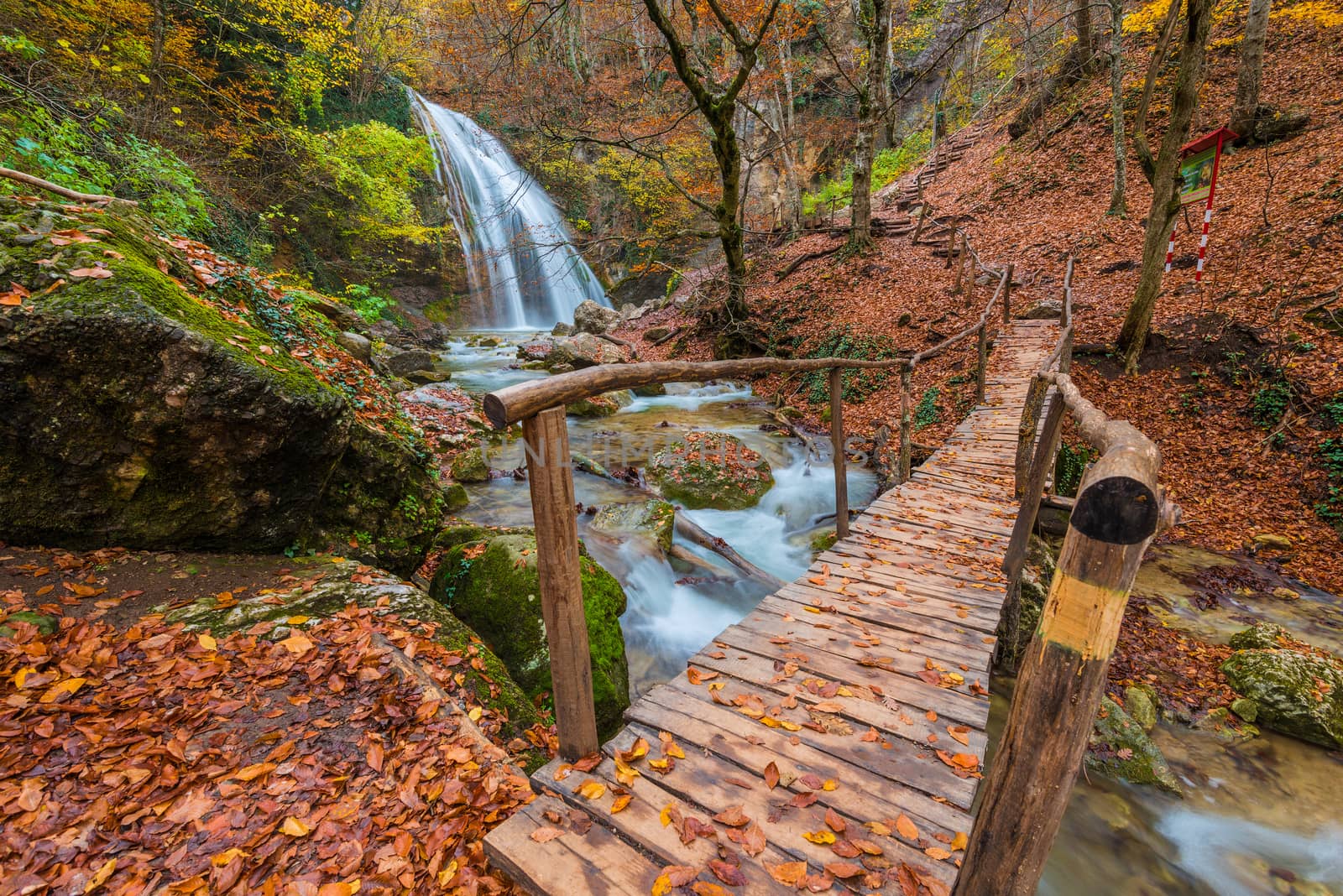 Autumn landscape of the Crimea, landmark Jur-Jur waterfall, in the foreground the bridge, Russia