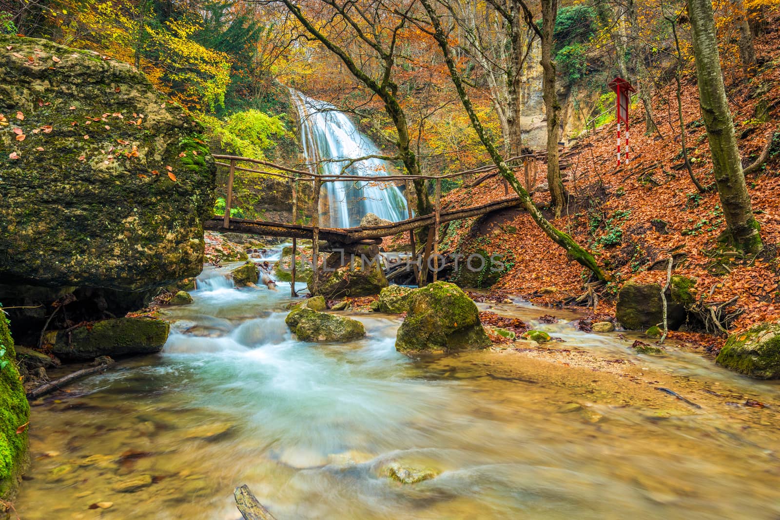 Large full-flowing waterfall Jur-Jur, postcard view in autumn, landmark of the Crimea peninsula, Russia